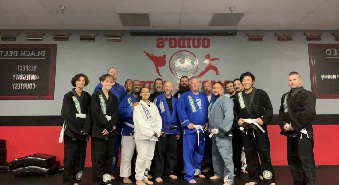 The black belt community at Guido's Martial Arts Academy posing together after class